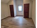 Spacious bedroom featuring hardwood floors, neutral paint, and two closets at 624 Warren Ave, Indianapolis, IN 46221