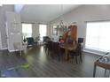 Spacious dining room featuring hardwood floors, modern lighting, neutral paint and lots of windows at 6422 Hollingsworth Dr, Indianapolis, IN 46268