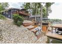 Lake house exterior featuring a tiered wooden deck and steps leading to the boat dock at 6497 Osprey Dr, Nineveh, IN 46164