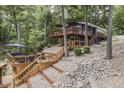 This lake house features an expansive wooden deck with lounge seating and steps to the water at 6497 Osprey Dr, Nineveh, IN 46164