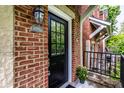 Close-up view of a brick home showcasing a dark front door and a well-kept exterior at 6556 Reserve Dr, Indianapolis, IN 46220