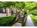 Inviting exterior view of a brick home featuring a stone foundation and a lush green garden at 6556 Reserve Dr, Indianapolis, IN 46220