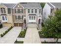 Aerial view of townhomes with well-manicured lawns, driveways, and brick and siding exteriors at 692 Greenford N Trl, Carmel, IN 46032