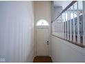 View of the foyer with hardwood floors, a white door, and staircase with wood and white railing at 692 Greenford N Trl, Carmel, IN 46032