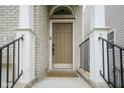 Close-up of the front door showcasing the covered entrance, white columns, and black railings at 692 Greenford N Trl, Carmel, IN 46032