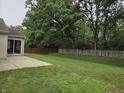 Expansive backyard featuring a concrete patio, wooden fence, and mature trees at 7440 Oakview Dr, Avon, IN 46123