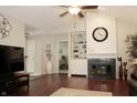 Inviting living room with vaulted ceilings, dark hardwood floors, fireplace, and built-in shelving at 7662 Micawber Ct, Indianapolis, IN 46256