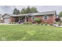 Beautiful brick home with a well-manicured lawn and inviting front porch, enhancing curb appeal at 784 S Restin Rd, Greenwood, IN 46142