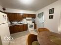 Efficient kitchen featuring wooden cabinets and white appliances at 7918 Bonita Ct, Indianapolis, IN 46219