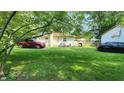 Expansive backyard with lush green grass, detached garage, offering plenty of space for outdoor activities at 8201 S Burlington Dr, Muncie, IN 47302