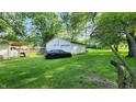 View of the detached garage with basketball hoop and driveway parking at 8201 S Burlington Dr, Muncie, IN 47302