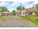 Property includes a detached garage, a spacious gravel driveway, and a well-maintained lawn at 850 Duane St, Franklin, IN 46131
