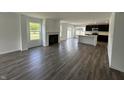 Open concept living space flows into kitchen, with vinyl flooring, fireplace, and plenty of natural light at 10144 Camp Creek Way, Indianapolis, IN 46229