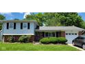 Charming two-story home with a brick facade and manicured lawn at 10210 E 33Rd St, Indianapolis, IN 46235