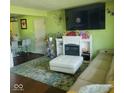 Bright living room with a fireplace, comfortable seating, and stylish decor at 10210 E 33Rd St, Indianapolis, IN 46235