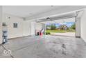 Two-car garage featuring an open garage door with exterior view of the neighborhood at 1139 Fernwood Way, Plainfield, IN 46168