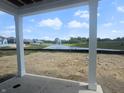 Backyard view towards neighborhood pond with fountain at 114 Velvet Hat Rd, Danville, IN 46122