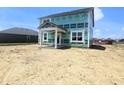 Two-story home with covered porch and green protective wrap at 114 Velvet Hat Rd, Danville, IN 46122