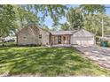 A beautiful ranch home featuring a stone exterior, attached garage, and well-manicured front lawn at 1205 Park Dr, Lebanon, IN 46052