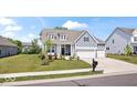 Attractive home with a well-kept lawn, two car garage, and appealing architectural details at 12078 Black Mill Pass, Fishers, IN 46040