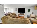 Comfortable living room with plush seating, a large TV, and neutral décor, creating a welcoming space at 1305 Gumwood Dr, Indianapolis, IN 46234