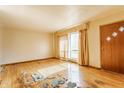 Bright and airy living room featuring hardwood floors and a large window, offering ample natural light at 1310 S Catherwood Ave, Indianapolis, IN 46203