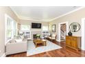 Bright living room featuring hardwood floors, fireplace, and large windows that provide ample natural light at 1325 Fordice Rd, Lebanon, IN 46052