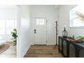 Bright entryway featuring wood floors and a stylish accent cabinet at 1425 Kennington St, Indianapolis, IN 46225