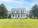 Charming two-story home with a welcoming front porch, dormer windows, and an American flag at 1595 N 400 W, Greenfield, IN 46140