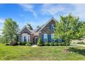 Charming brick home featuring beautiful landscaping, a well-manicured lawn, and inviting curb appeal at 1631 Caspian Dr, Carmel, IN 46032