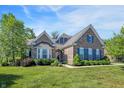 Charming brick home featuring beautiful landscaping, a well-manicured lawn, and inviting curb appeal at 1631 Caspian Dr, Carmel, IN 46032