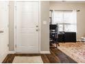 Entryway with hardwood floors, a white door, and natural light streaming through the office window at 17183 Petersfield Ln, Westfield, IN 46074