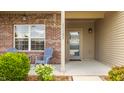 Inviting front porch featuring brick accents, vinyl siding, and outdoor seating at 17183 Petersfield Ln, Westfield, IN 46074