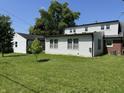 Spacious backyard with green grass, bordered by mature trees and privacy at 2211 Rosedale Dr, Indianapolis, IN 46227