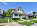 Inviting two-story home with a charming front porch, manicured lawn, and classic architectural details at 238 S 5Th Ave, Beech Grove, IN 46107