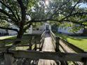 Exterior of house featuring a wooden ramp leading to front door, shaded by a large tree at 2509 S New Jersey St, Indianapolis, IN 46225