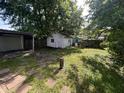 View of home's outbuilding situated in a shady backyard with stepping stone pavers at 2509 S New Jersey St, Indianapolis, IN 46225