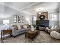 Cozy living room featuring a decorative fireplace, exposed brick, and neutral décor at 2954 N Washington Blvd, Indianapolis, IN 46205