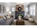 Bright living room with a brick fireplace, ample seating, and a decorative rug at 2954 N Washington Blvd, Indianapolis, IN 46205