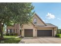 Charming home featuring a brick and vinyl exterior with a spacious three-car garage and well-maintained lawn at 301 Cobblesprings Ct, Avon, IN 46123