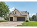 Spacious three-car garage with ample parking space and a well-manicured lawn surrounding the property at 301 Cobblesprings Ct, Avon, IN 46123