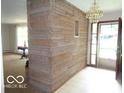 Bright entryway featuring a unique stone wall and chandelier at 3253 W 34Th St, Indianapolis, IN 46222