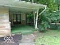 Inviting covered porch with stone accents and peaceful surroundings at 3253 W 34Th St, Indianapolis, IN 46222