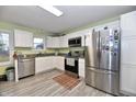 Modern kitchen with stainless steel appliances, white cabinets, and granite countertops at 335 Park St, Noblesville, IN 46060