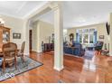 Bright open concept showcases hardwood floors connecting living and dining spaces at 3559 Towne Dr, Carmel, IN 46032