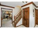 Inviting foyer with hardwood floors, staircase, and wood trim with an open view to the living room at 380 Raintree Dr, Zionsville, IN 46077