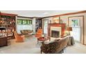 Cozy living room with fireplace, built-in shelving, and an abundance of natural light at 380 Raintree Dr, Zionsville, IN 46077
