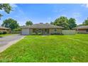 Charming single-story home with a well-manicured lawn, stone details, and a welcoming entrance at 45 Kirk E Dr, Indianapolis, IN 46234