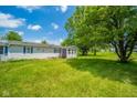 Expansive backyard featuring lush greenery, mature trees, and ample space for outdoor activities at 4644 E 150 N, Anderson, IN 46012