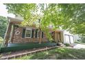 Inviting front porch with wooden beams, brick accents, and hanging plants at 6028 Thornwood Ct, Indianapolis, IN 46250